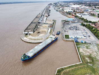 Drone photograph of a large vessel being towed into albert dock, hull, uk