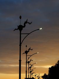 Low angle view of street light against sky at sunset