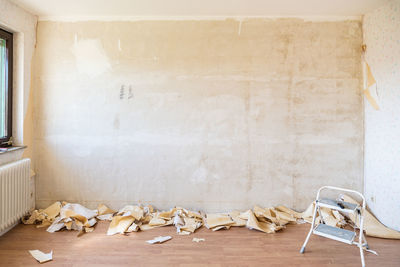 Garbage on table against white wall