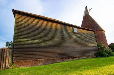 Low angle view of house on field against sky