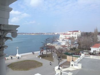 High angle view of buildings by sea against sky