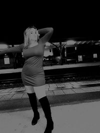 Full length of woman standing at railroad station