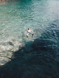 High angle view of man swimming in sea