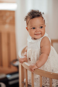 Portrait of cute baby girl at home