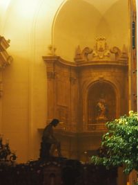 People standing outside temple in building