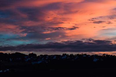 Silhouette landscape against scenic sky
