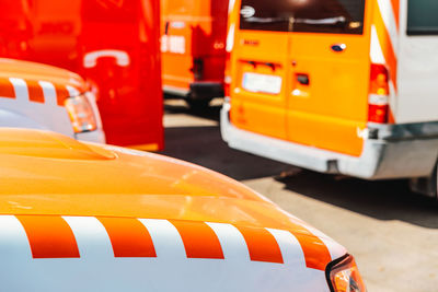 Close-up of yellow car on road