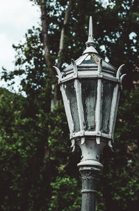 Low angle view of street light against trees