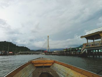 View of bridge over river against cloudy sky