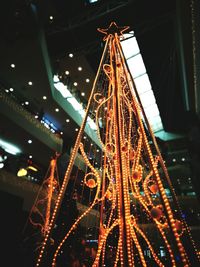 Low angle view of illuminated christmas lights at night