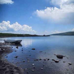 Scenic view of lake against cloudy sky