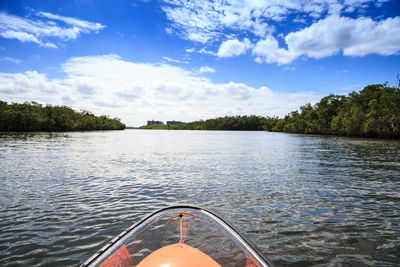 Clear see-through kayak forges its way through the waters of delnor-wiggins pass in bonita springs,