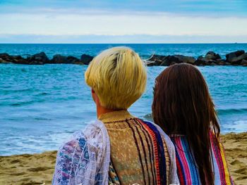 Rear view of friends at beach