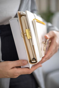 Cropped hand of woman holding book