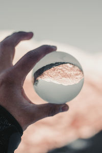 Close-up of hand holding coffee cup
