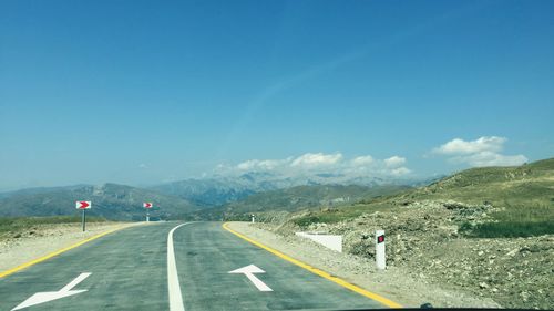 Road on mountain against blue sky