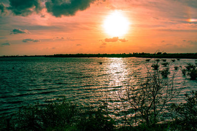 Scenic view of lake against sky during sunset