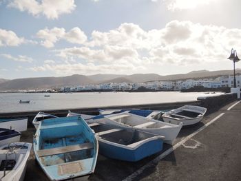 Boats moored on sea against sky