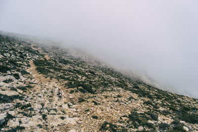 Aerial view of landscape against sky during foggy weather