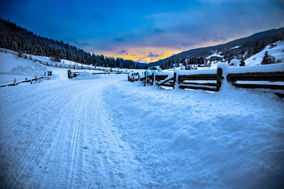 Snow covered landscape against sky