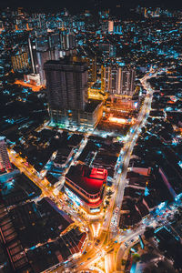 High angle view of city lit up at night