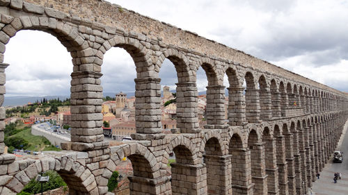 Low angle view of old ruins against cloudy sky