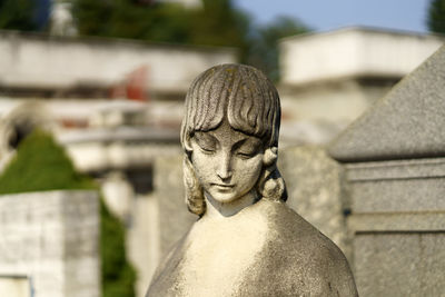 Close-up of angel statue in cemetery