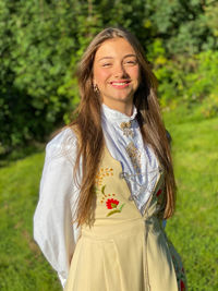 Portrait of a smiling young girl selebrating confirmation in bunad 