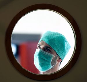 Reflection of doctor in mirror