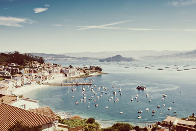 High angle view of townscape by sea against sky