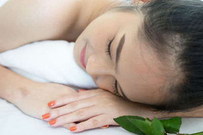 Young woman lying on massage table in spa