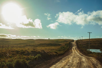 Deserted dirt road passing through rural lowlands with sunlight near cambará do sul. brazil.