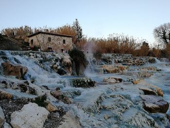 Scenic view of waterfall against clear sky
