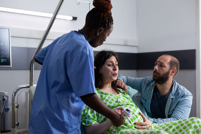 Side view of doctor examining patient at home