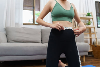 Low section of woman exercising in gym