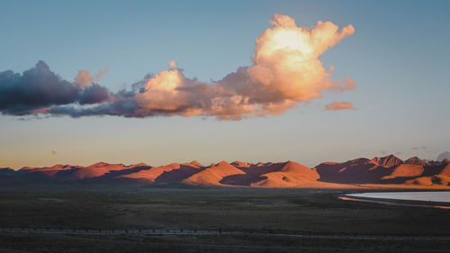 Scenic view of land against sky during sunset