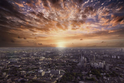 Aerial view of cityscape against sky during sunset