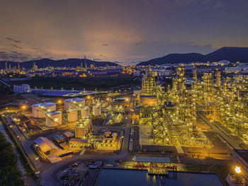 High angle view of illuminated city against sky at night