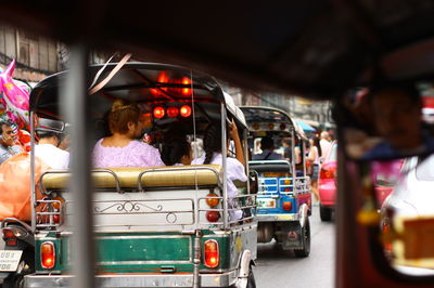 Rear view of auto rickshaws on road