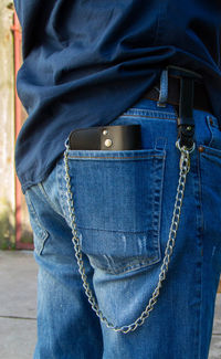 Rear view of man standing against blue wall