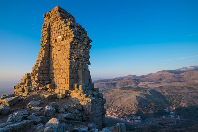 View of rock formation against blue sky