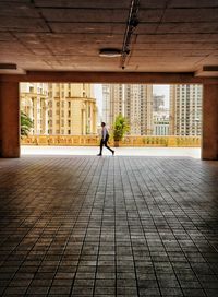 Rear view of woman walking on walkway