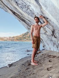 Young man standing on beach