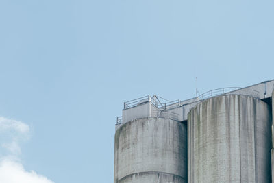 Low angle view of smoke stack against sky