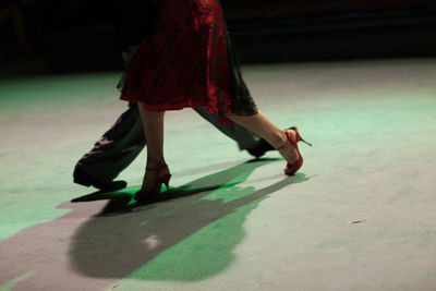 Low section of woman dancing on street