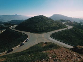 High angle view of winding road on field against sky