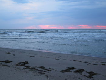 Scenic view of beach against sky during sunset