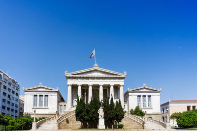 Low angle view of government building against clear blue sky