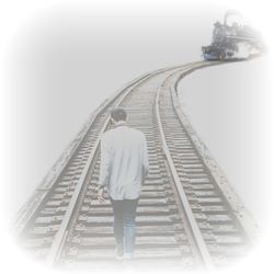 Rear view of man walking on railroad track