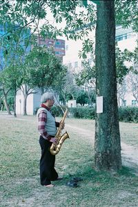 Man holding tree trunk by plants